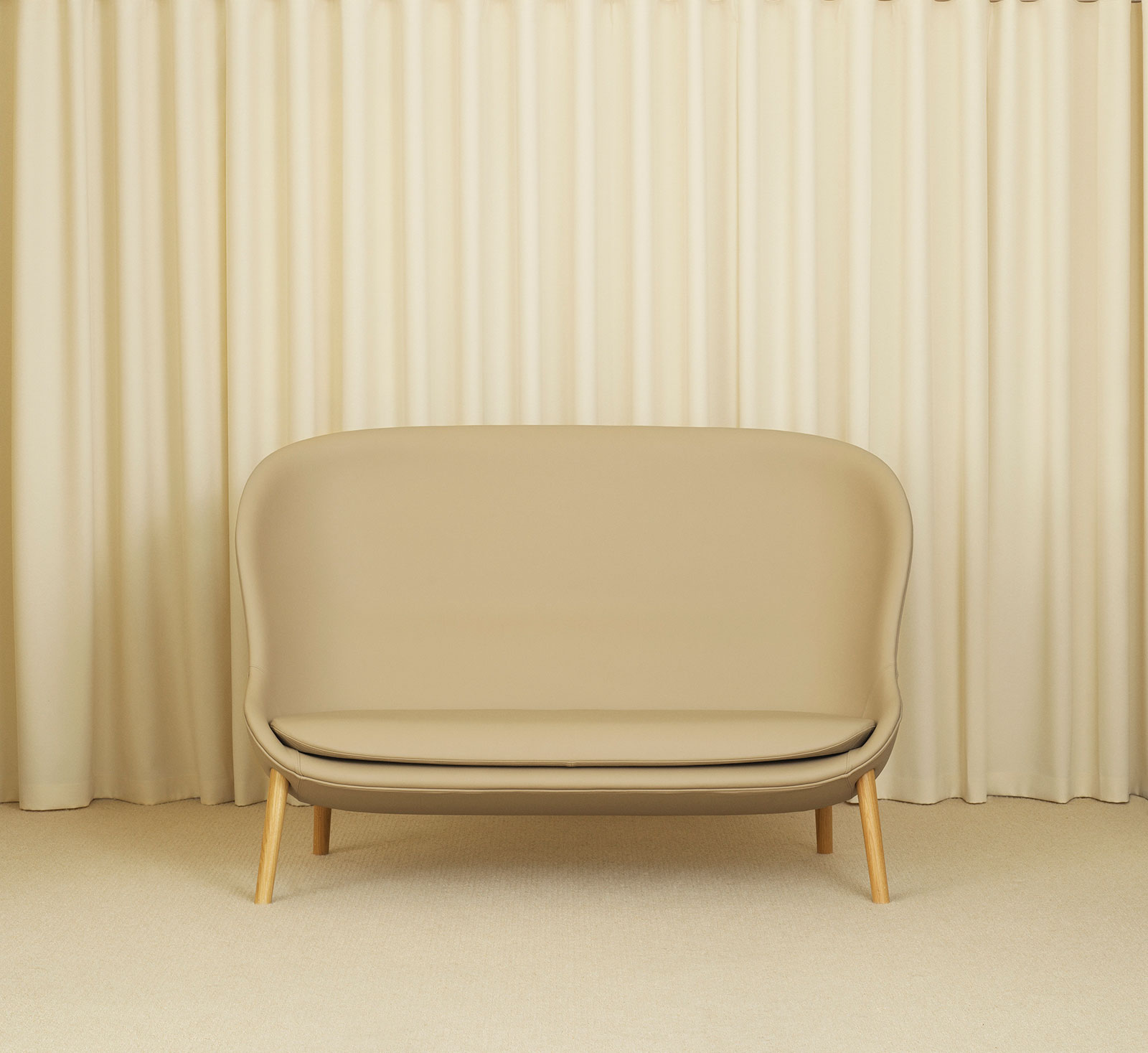 Hyg Sofa in front of beige curtains